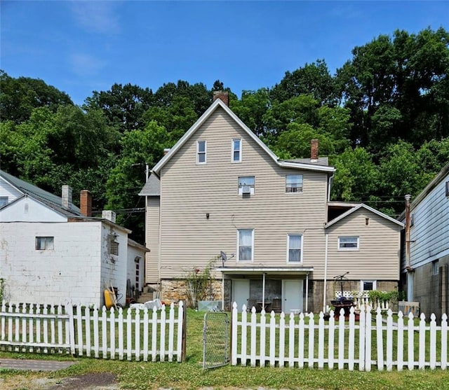 back of property featuring a yard