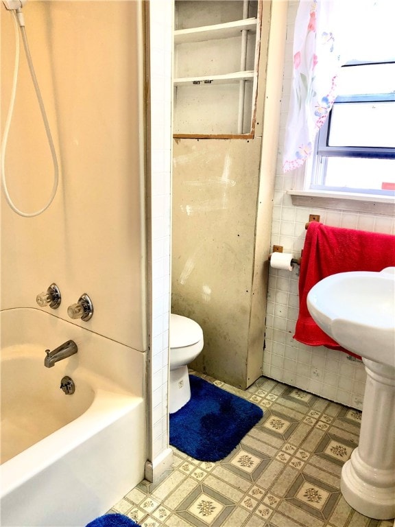 bathroom with shower / tub combination and toilet