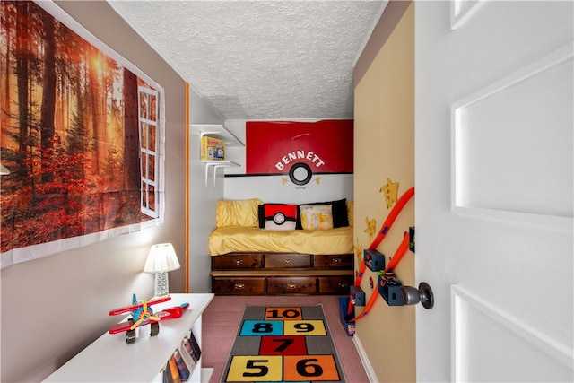 recreation room featuring a textured ceiling and carpet flooring