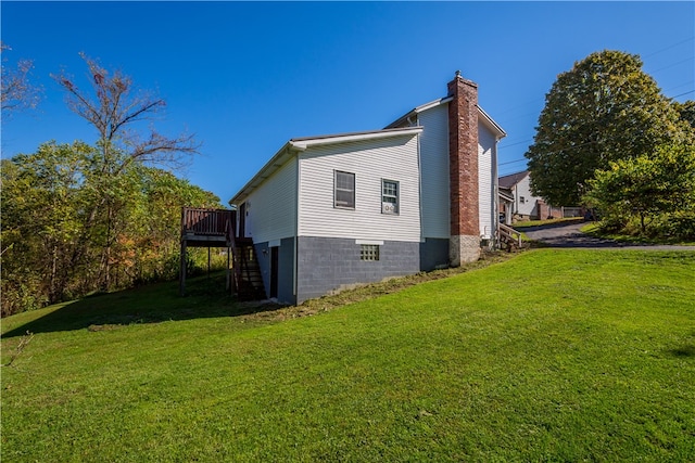 view of property exterior featuring a lawn and a deck