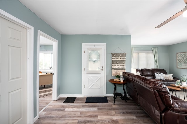 foyer with light wood-type flooring and ceiling fan