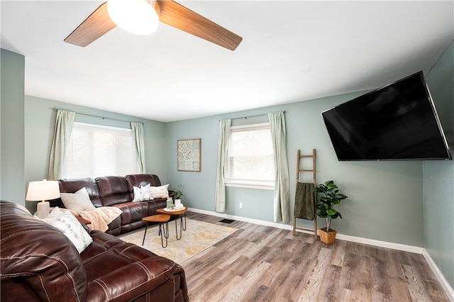 living room featuring ceiling fan and hardwood / wood-style flooring