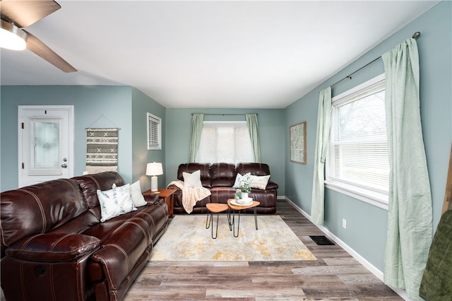 living room with hardwood / wood-style floors, plenty of natural light, and ceiling fan