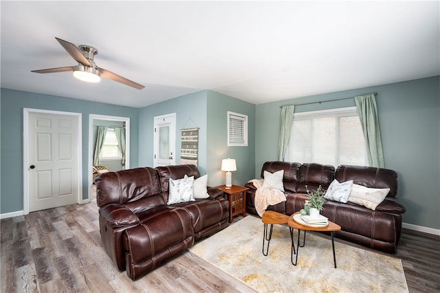 living room with wood-type flooring and ceiling fan