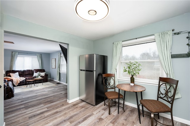 kitchen with light hardwood / wood-style floors and stainless steel refrigerator