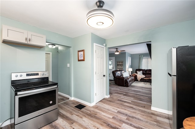 kitchen with appliances with stainless steel finishes, light hardwood / wood-style flooring, white cabinetry, and ceiling fan