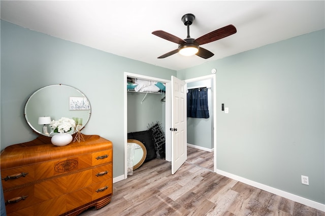 bedroom with light wood-type flooring, a closet, and ceiling fan