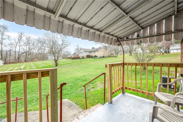 deck featuring central AC unit and a yard