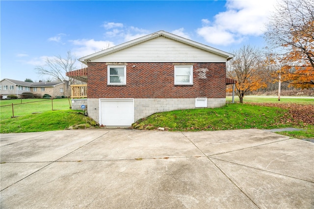 view of side of home with a garage and a yard