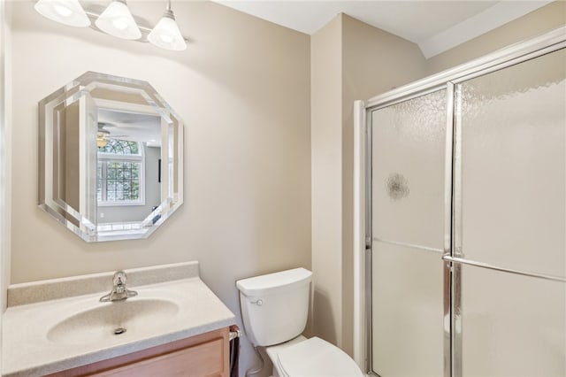 bathroom with vanity, toilet, ceiling fan, and an enclosed shower