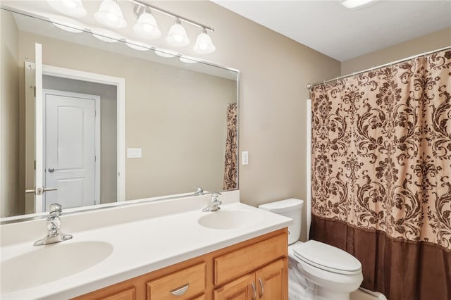 bathroom with vanity, toilet, and curtained shower