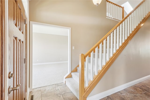 staircase with a skylight