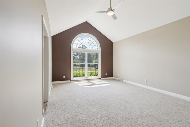 unfurnished room with high vaulted ceiling, ceiling fan, and light colored carpet