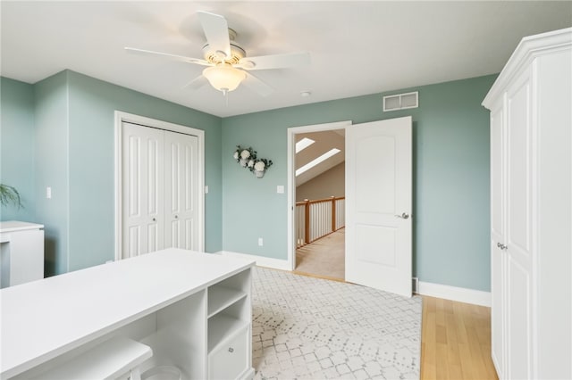 interior space with ceiling fan and light hardwood / wood-style flooring