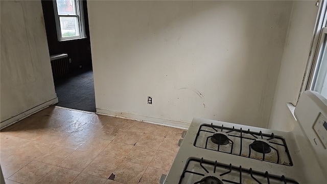 unfurnished room featuring radiator heating unit