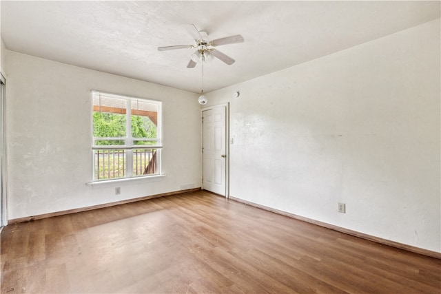 spare room with wood-type flooring and ceiling fan