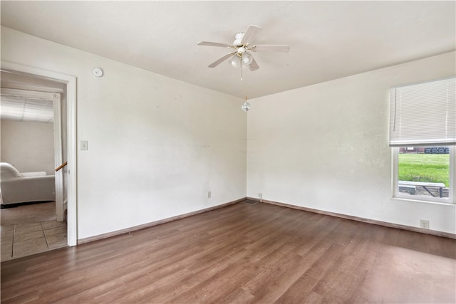 empty room with hardwood / wood-style floors and ceiling fan