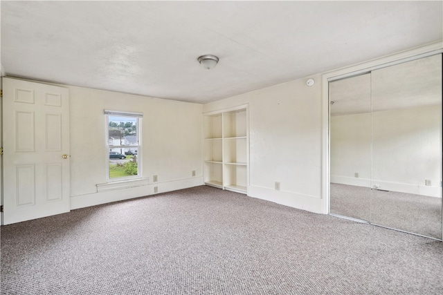 unfurnished bedroom featuring carpet floors and a closet