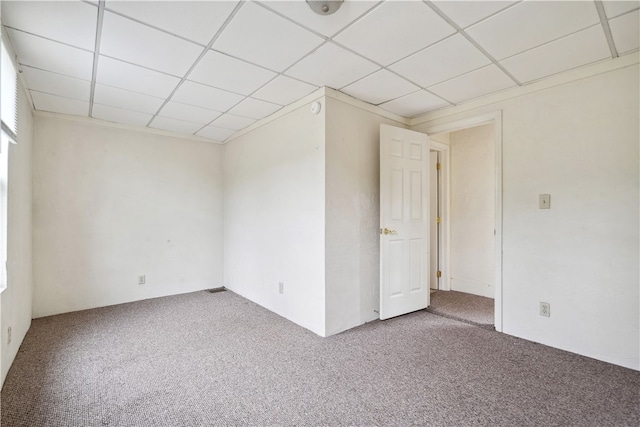 spare room with a drop ceiling and carpet floors