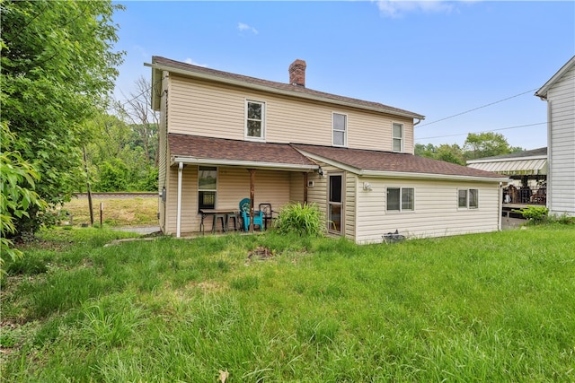 rear view of house with a lawn