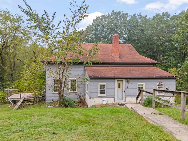 back of house with a lawn