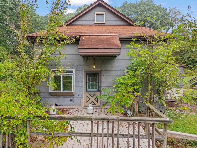 exterior space with roof with shingles