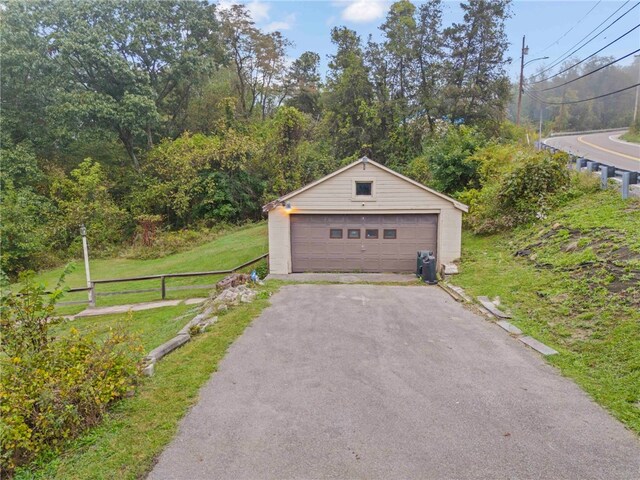 detached garage featuring fence