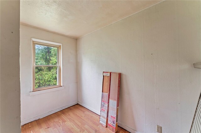 unfurnished room with baseboards and light wood-style floors