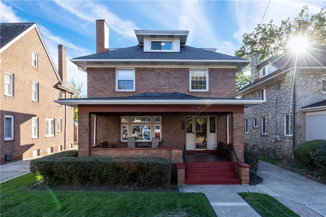 view of front of home featuring a front yard and covered porch