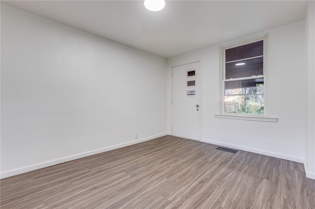 unfurnished room featuring light hardwood / wood-style floors