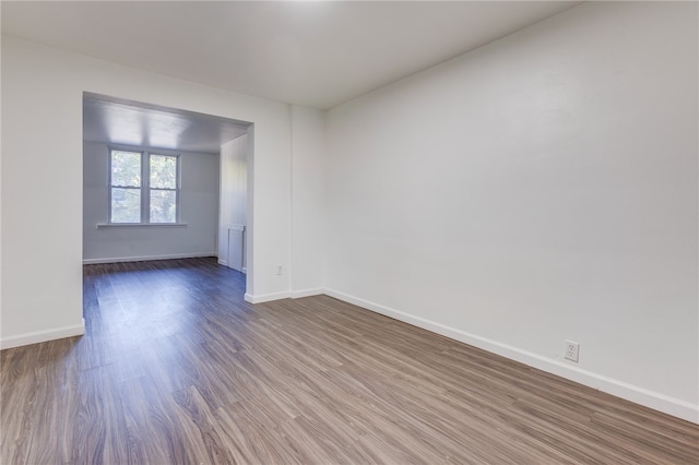 spare room with wood-type flooring