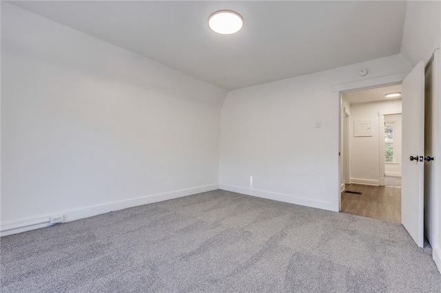 empty room with vaulted ceiling and carpet