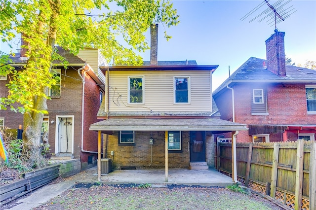 back of property with a patio and central AC unit