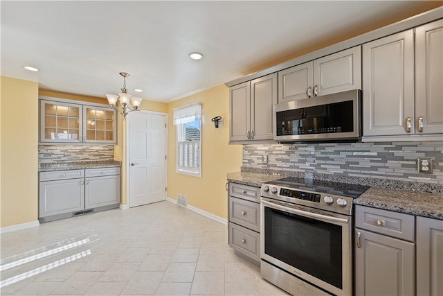 kitchen featuring gray cabinetry, stainless steel appliances, and decorative backsplash