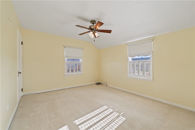 carpeted empty room featuring lofted ceiling and ceiling fan