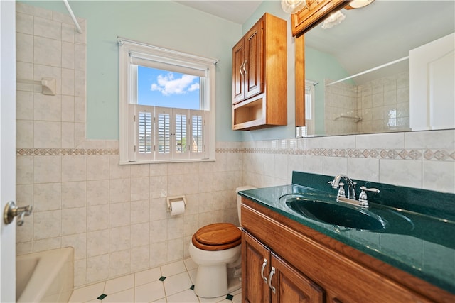 full bathroom with tile walls, bathing tub / shower combination, vanity, tile patterned flooring, and toilet