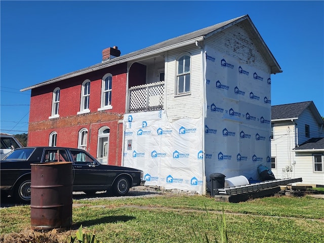 view of home's exterior featuring brick siding and a chimney