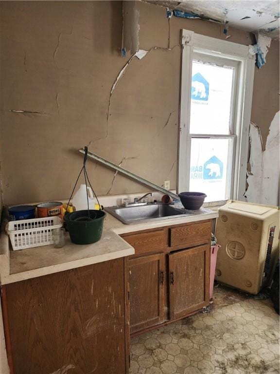 kitchen with light countertops and a sink