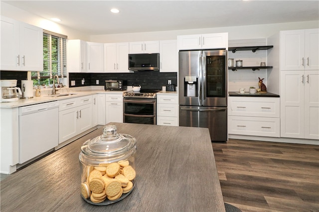 kitchen with dark hardwood / wood-style floors, white cabinetry, sink, and stainless steel appliances