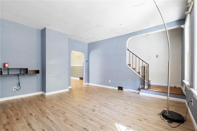 21 Ambridge Ave, Leet Twp, PA 15003 - unfurnished living room featuring arched walkways, wood finished floors, stairs, and baseboards