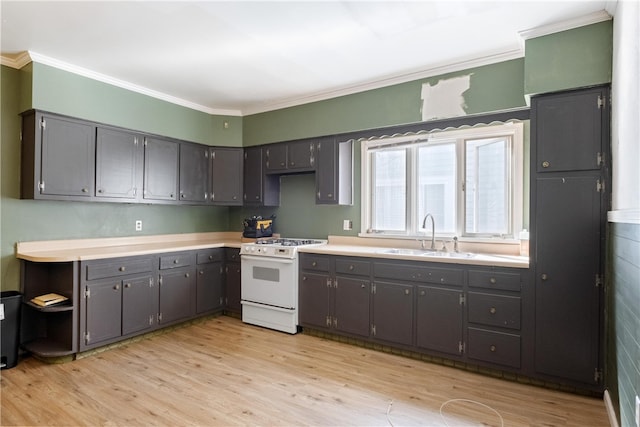 kitchen with white range oven, crown molding, light hardwood / wood-style floors, and sink