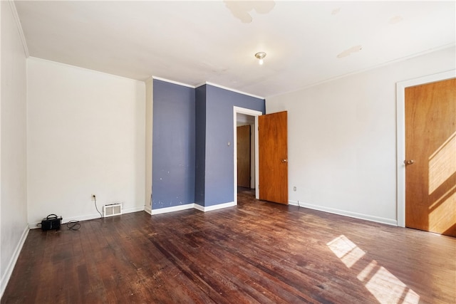 unfurnished room with crown molding and dark wood-type flooring