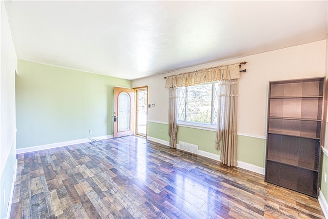 empty room with hardwood / wood-style flooring