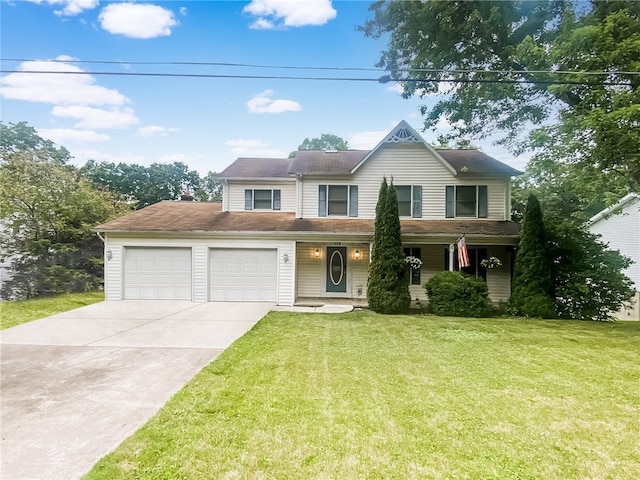 view of property with a garage and a front lawn