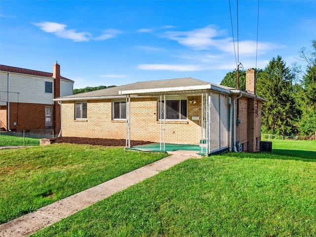 view of side of home with a yard