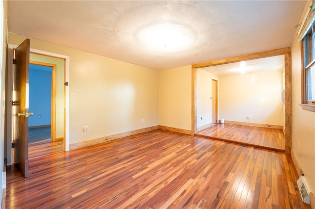 unfurnished room featuring hardwood / wood-style floors