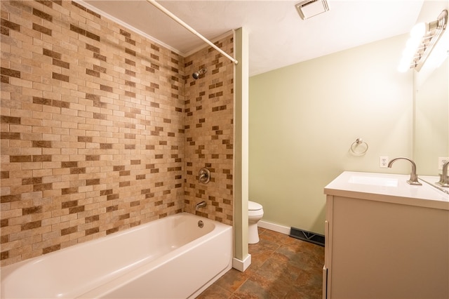 full bathroom with vanity, tiled shower / bath, and toilet