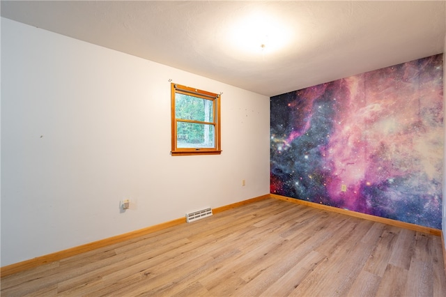 spare room with light wood-type flooring