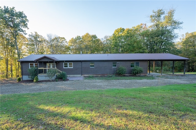 view of front of property with a front yard and a carport