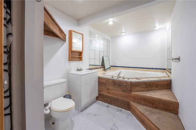 bathroom with a tub to relax in, vanity, and toilet